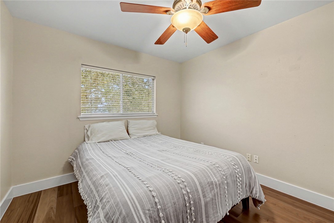 7541 Yorkshire Drive Corpus Christi, TX 78413 - Photo 22 of 32 a bedroom with a bed and a chandelier