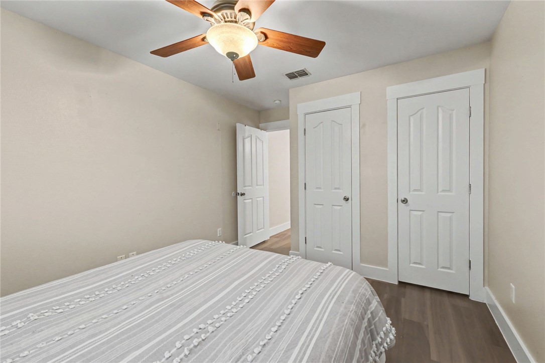 7541 Yorkshire Drive Corpus Christi, TX 78413 - Photo 24 of 32 a bedroom with a bed and a chandelier fan
