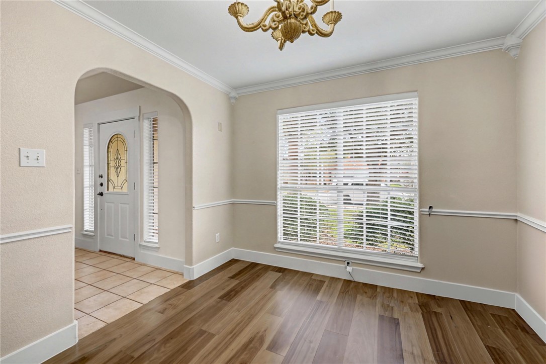 7541 Yorkshire Drive Corpus Christi, TX 78413 - Photo 5 of 32 an empty room with wooden floor and windows