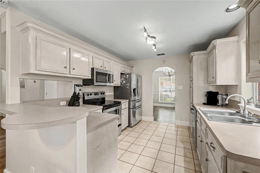 7541 Yorkshire Drive Corpus Christi, TX 78413 - Photo 9 of 32 a kitchen with a sink stove and refrigerator