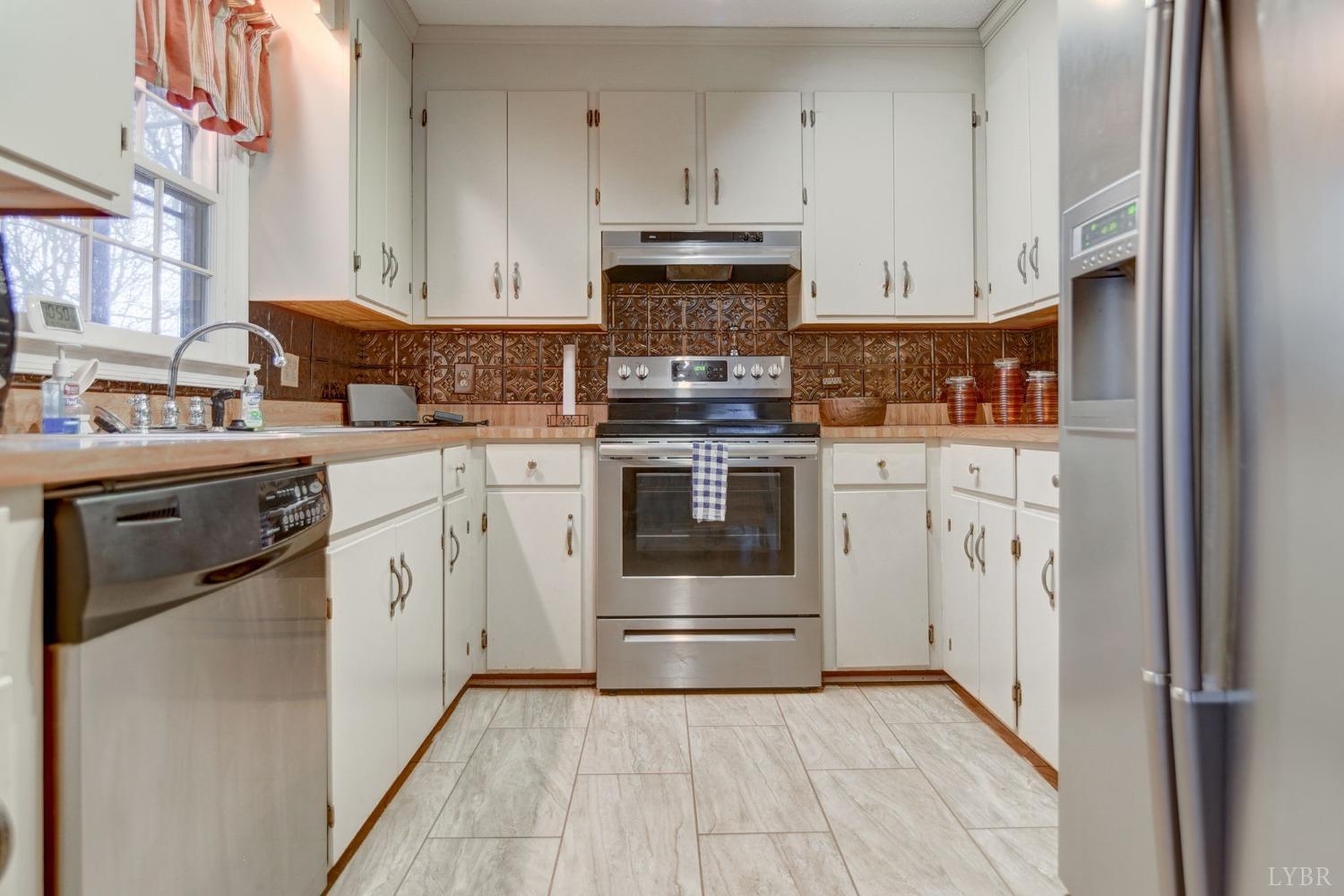 161 River Ridge Road Madison Heights, VA 24572 - Photo 6 of 36 a kitchen with stainless steel appliances granite countertop a stove a sink and a refrigerator
