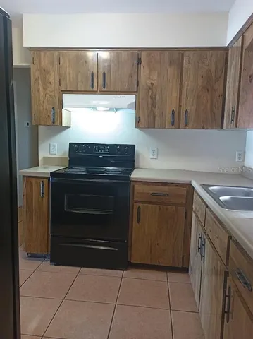a kitchen with a stove and a sink