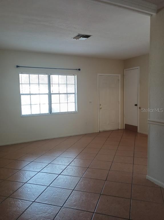 6726 Carnelian Avenue New Port Richey, FL 34653 - Photo 5 of 13 a view of an empty room with a window