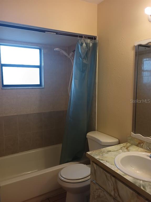 6726 Carnelian Avenue New Port Richey, FL 34653 - Photo 6 of 13 a bathroom with a sink toilet and shower
