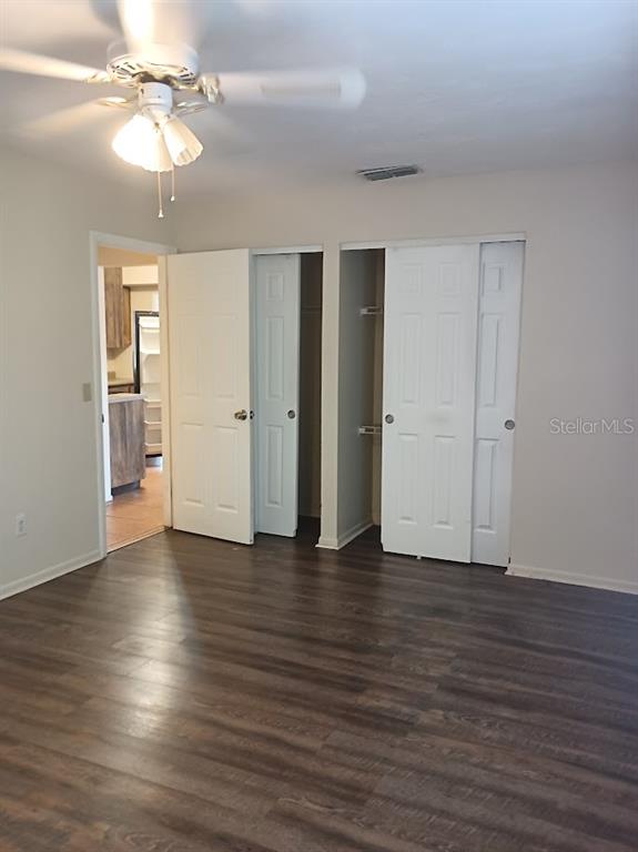 6726 Carnelian Avenue New Port Richey, FL 34653 - Photo 7 of 13 a view of an empty room with window and wooden floor