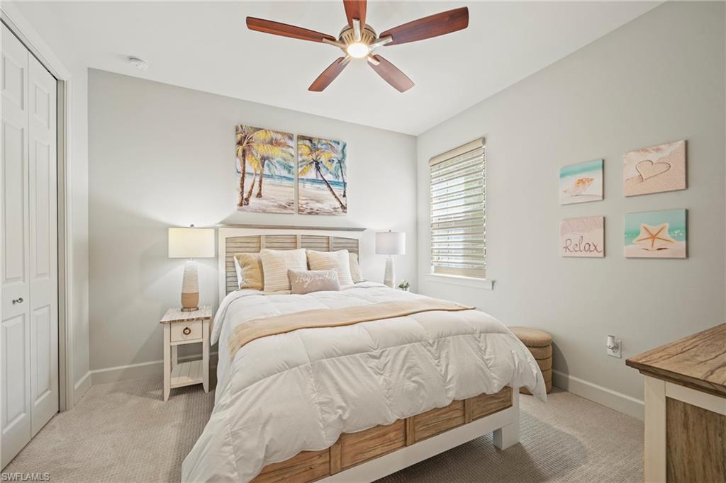10231 Glastonbury Circle, Unit 101 Fort Myers, FL 33913 - Photo 12 of 35 a bedroom with a bed and painting on the wall
