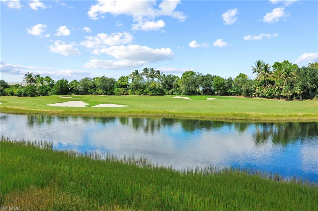 10231 Glastonbury Circle, Unit 101 Fort Myers, FL 33913 - Photo 18 of 35 a view of a lake with a yard