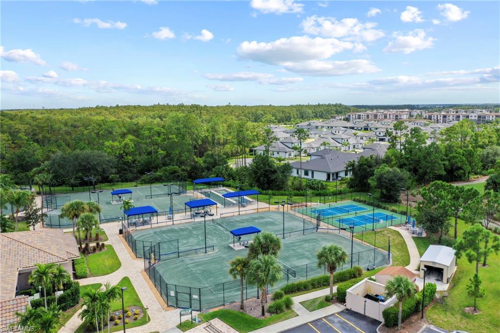 10231 Glastonbury Circle, Unit 101 Fort Myers, FL 33913 - Photo 33 of 35 a view of a swimming pool and lounge chairs in back yard of the house