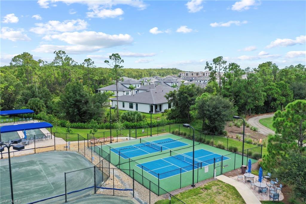 10231 Glastonbury Circle, Unit 101 Fort Myers, FL 33913 - Photo 35 of 35 a view of a patio with a table and chairs under an umbrella