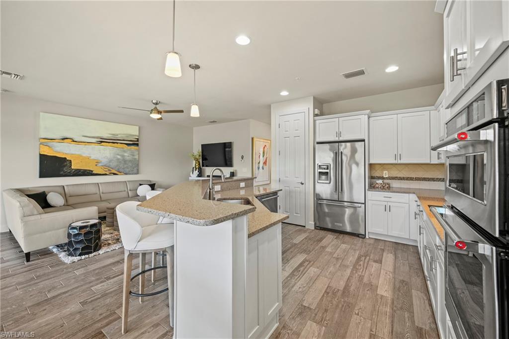 10231 Glastonbury Circle, Unit 101 Fort Myers, FL 33913 - Photo 5 of 35 a kitchen with a sink appliances and cabinets