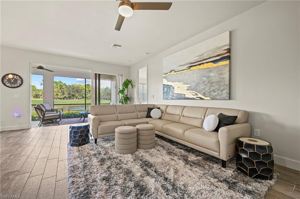 10231 Glastonbury Circle, Unit 101 Fort Myers, FL 33913 - Photo 6 of 35 a living room with furniture and a large window