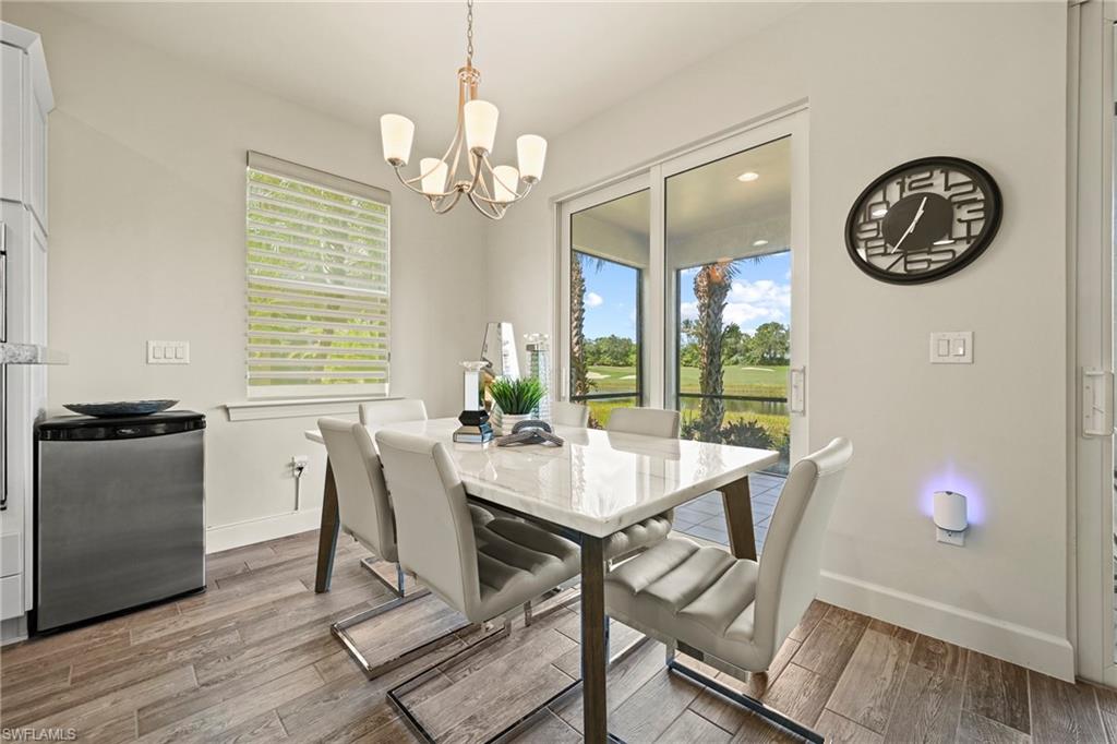 10231 Glastonbury Circle, Unit 101 Fort Myers, FL 33913 - Photo 7 of 35 a view of a dining room with furniture window and wooden floor