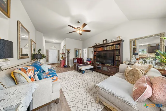 a living room with furniture a flat screen tv and a fireplace