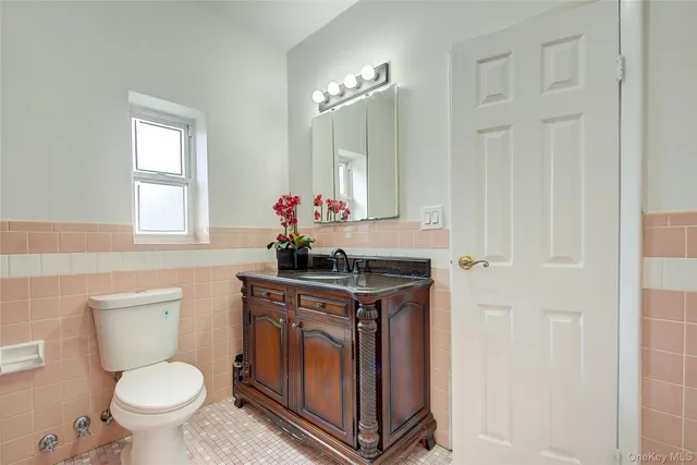 a bathroom with a toilet a sink and a window