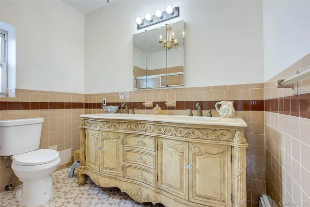 a bathroom with a toilet a sink and mirror