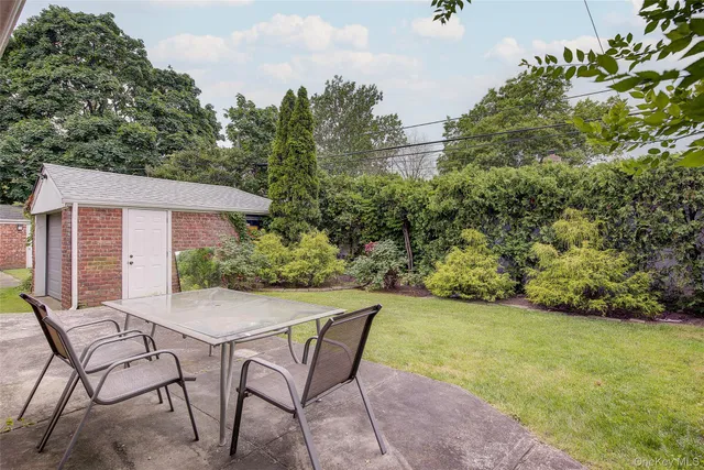 an outdoor space with furniture and garden