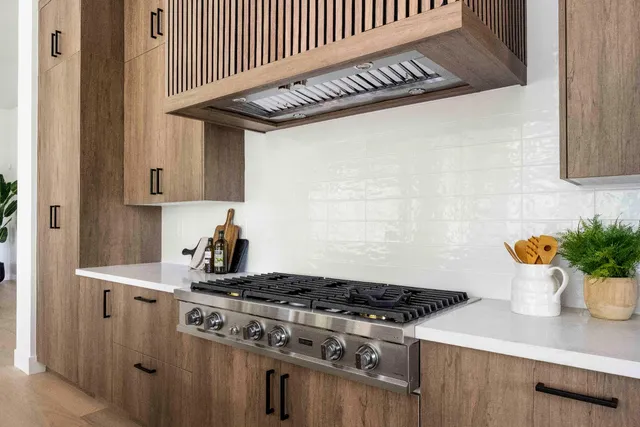 a white stove top oven sitting inside of a kitchen