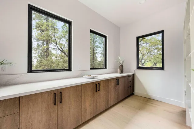 a large white kitchen with a large window