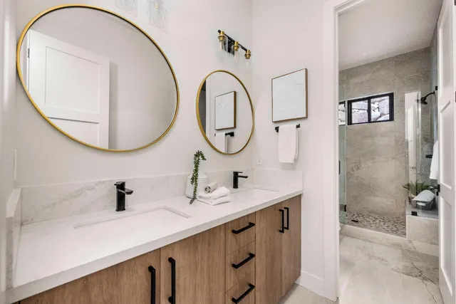 a bathroom with a double vanity sink and a mirror