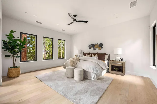 a bedroom with a large bed and a large window