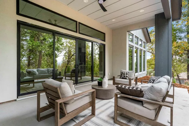 a living room with furniture and a floor to ceiling window
