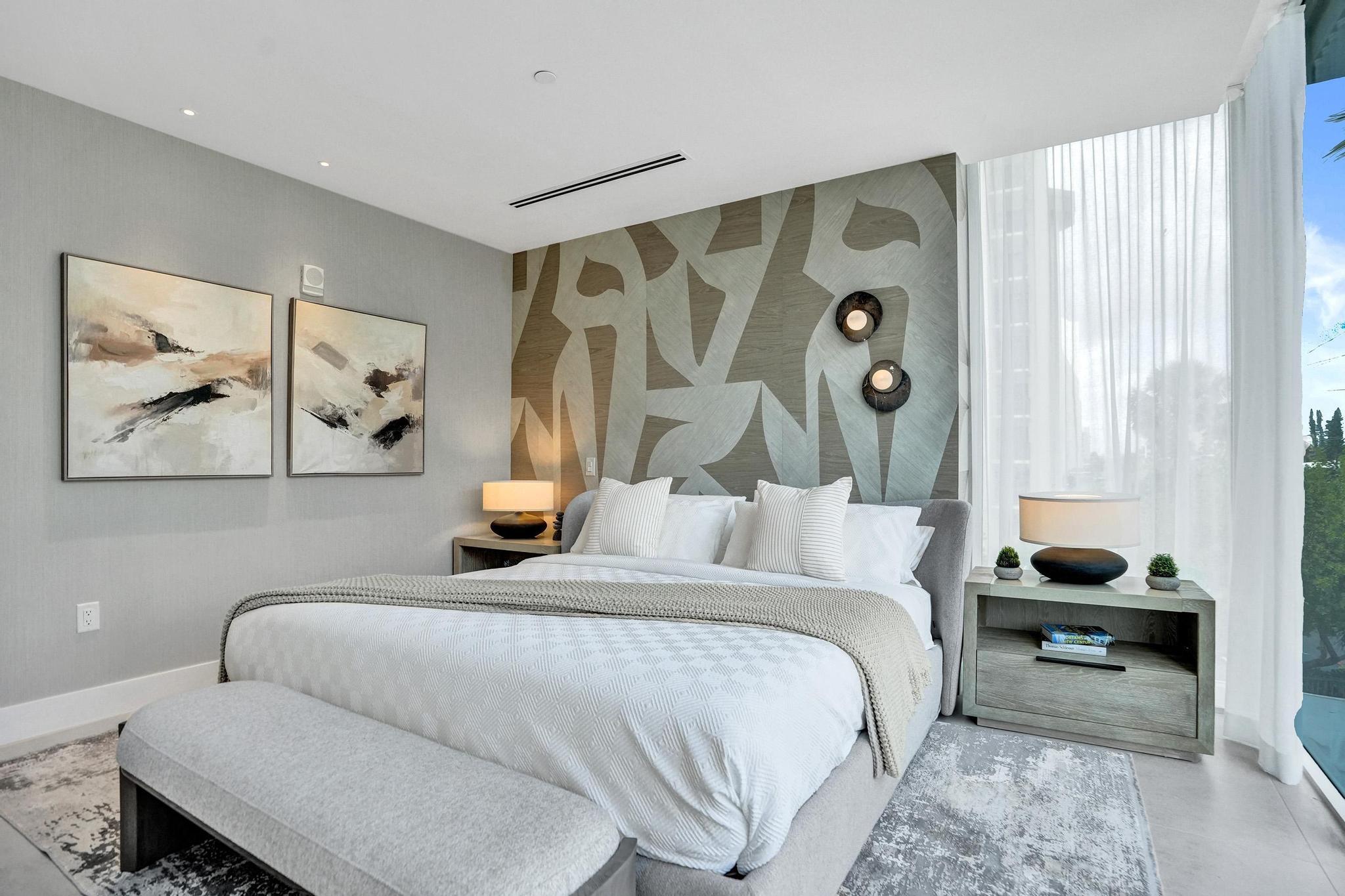 407 North Riverside Drive, Unit 203 Pompano Beach, FL 33062 - Photo 22 of 69 a bedroom with a bed and a painting on the wall