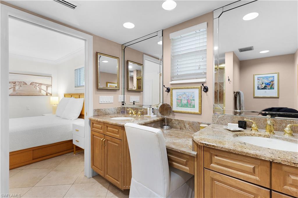 445 3rd Avenue South, Unit 102 Naples, FL 34102 - Photo 19 of 22 a bathroom with a granite countertop sink mirror and a