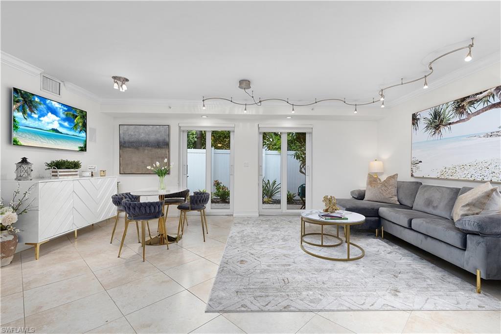 445 3rd Avenue South, Unit 102 Naples, FL 34102 - Photo 3 of 22 a living room with furniture and a large window