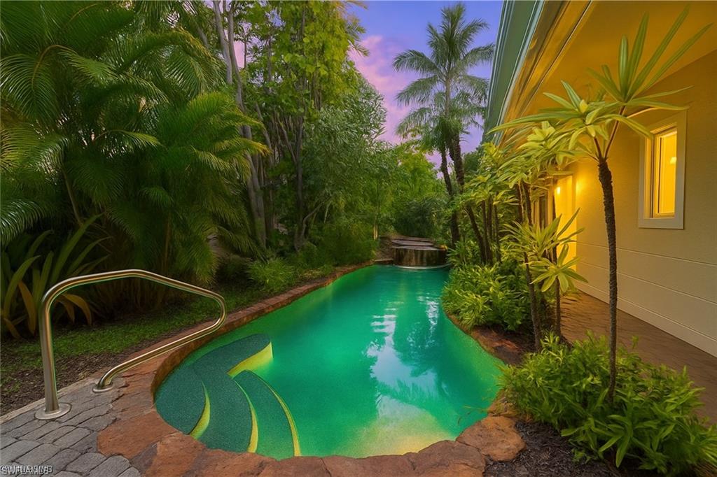 445 3rd Avenue South, Unit 102 Naples, FL 34102 - Photo 7 of 22 a view of a swimming pool with a yard