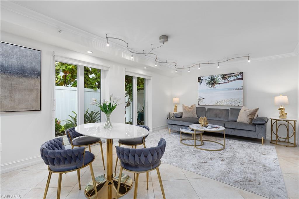 445 3rd Avenue South, Unit 102 Naples, FL 34102 - Photo 10 of 22 a living room with furniture and a large window