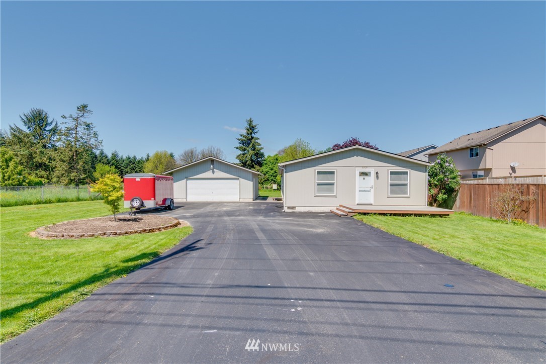 5509 Mt Solo Road Longview, WA 98632 - Photo 1 of 22 a front view of a house with a yard and garage