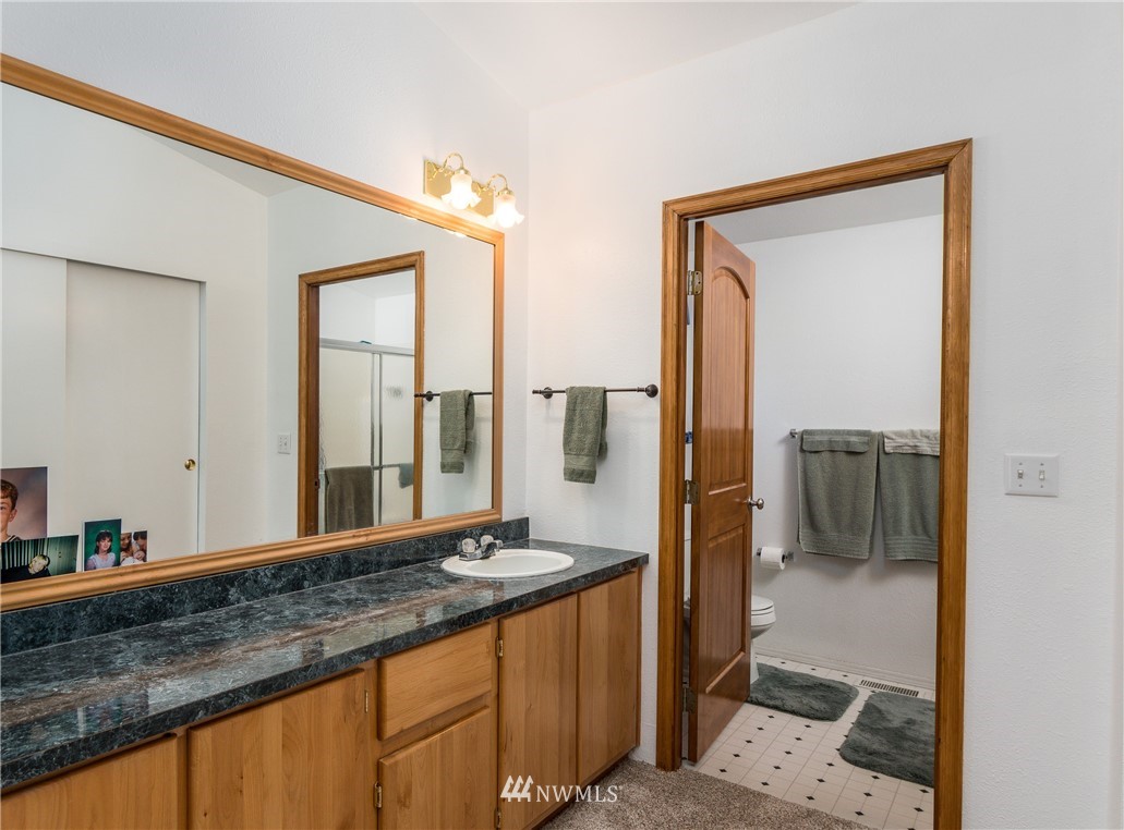 5509 Mt Solo Road Longview, WA 98632 - Photo 11 of 22 a bathroom with a granite countertop sink and a mirror