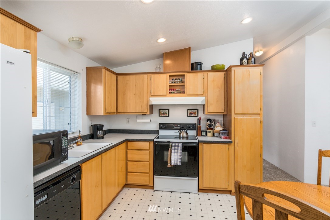 5509 Mt Solo Road Longview, WA 98632 - Photo 4 of 22 a kitchen with stainless steel appliances granite countertop a sink stove and refrigerator