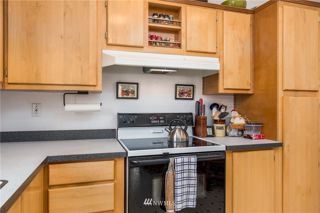 5509 Mt Solo Road Longview, WA 98632 - Photo 5 of 22 a kitchen with stainless steel appliances granite countertop a sink and cabinets