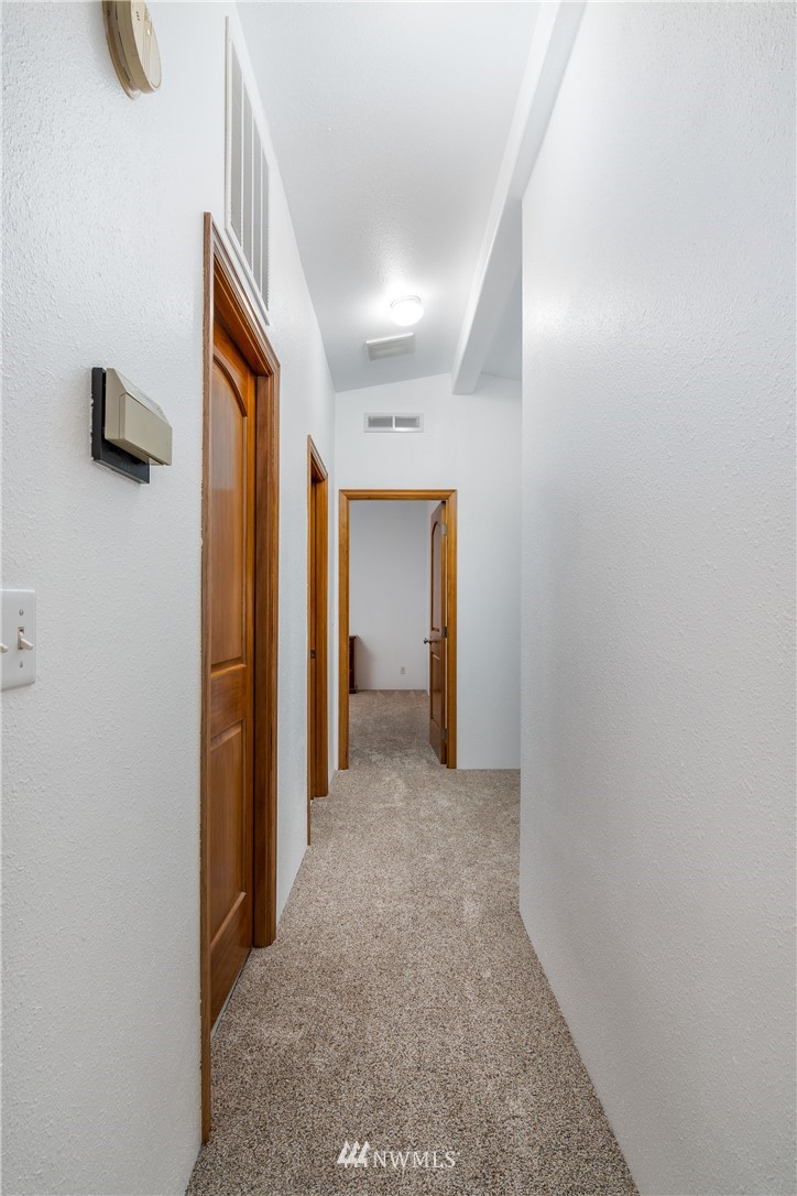 5509 Mt Solo Road Longview, WA 98632 - Photo 7 of 22 a view of a hallway with wooden shelves