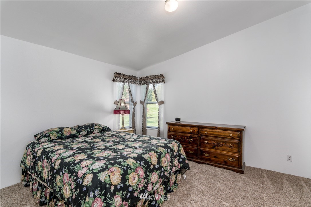 5509 Mt Solo Road Longview, WA 98632 - Photo 8 of 22 a bed sitting in a bedroom next to a window