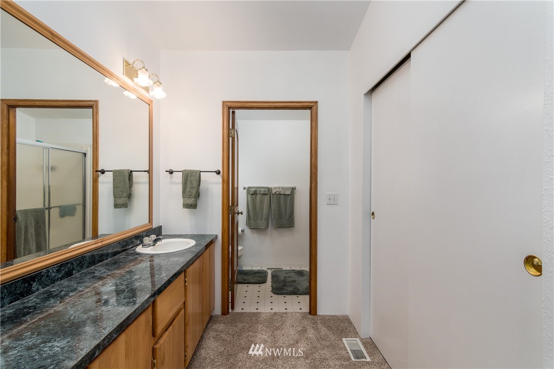 5509 Mt Solo Road Longview, WA 98632 - Photo 10 of 22 a bathroom with a granite countertop sink and a mirror
