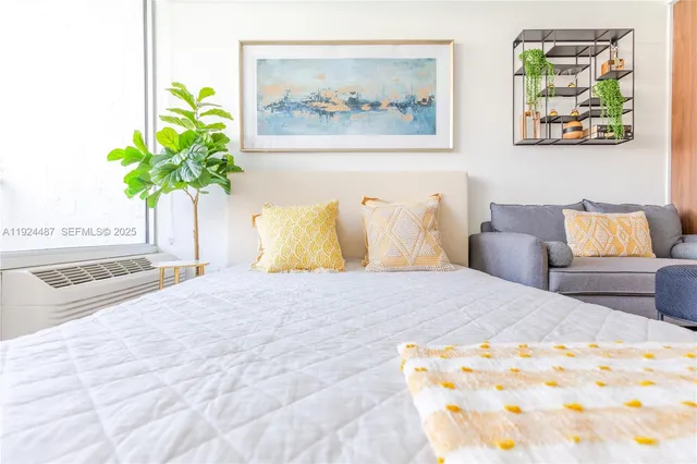 a bedroom with a bed and a painting on the wall