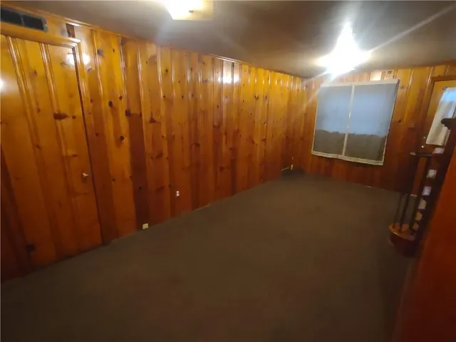 a view of a room with a wooden door