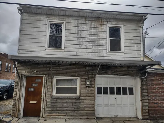a view of a house with more windows and brick walls