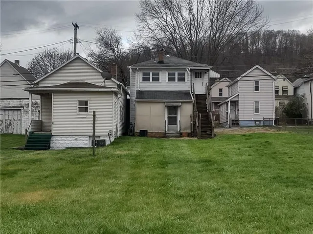 a front view of house with yard and green space