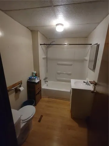 a bathroom with a granite countertop sink mirror vanity and toilet