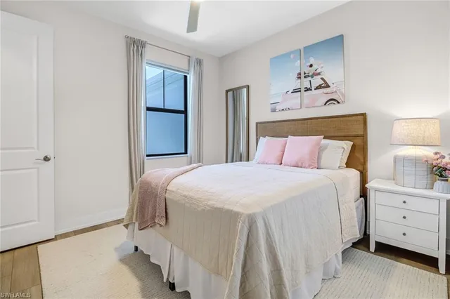 a bedroom with a bed and a painting on the wall