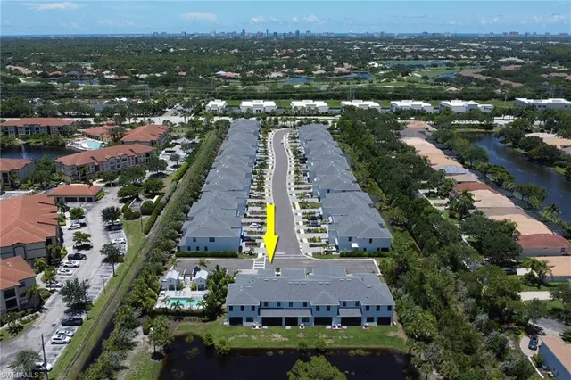 an aerial view of residential houses with outdoor space and river