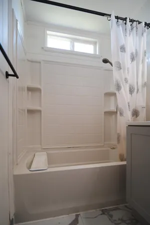 a spacious bedroom with a bed and a tv