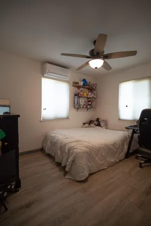 a bed room with a bed and a mirror