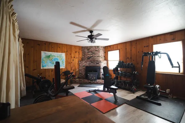a living room with furniture gym equipment and a fireplace