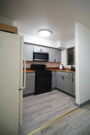 a kitchen with a sink stove and microwave
