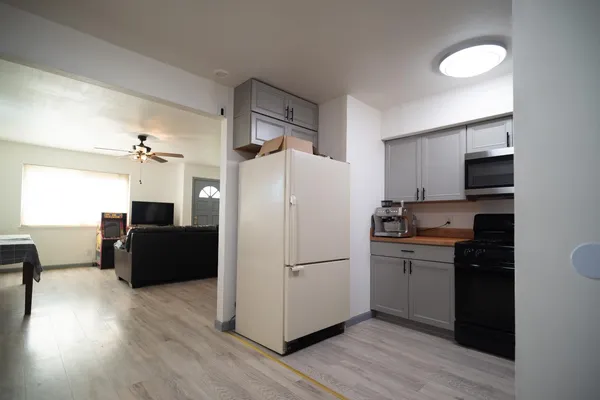 a kitchen with stainless steel appliances a refrigerator and a stove top oven