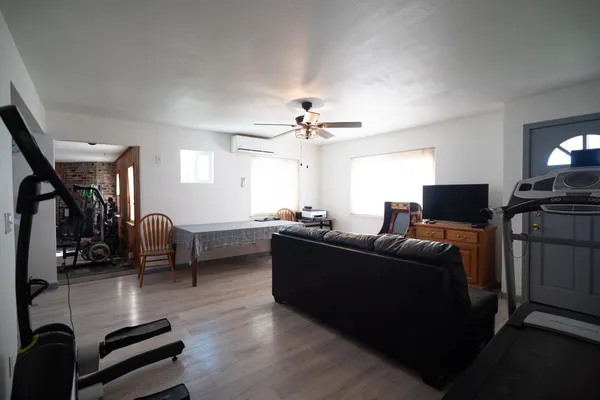 a living room with furniture and a wooden floor